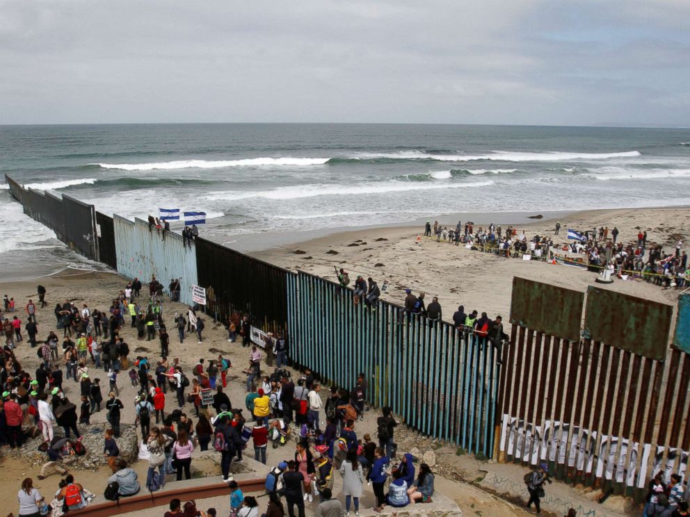 PHOTO: Members of a caravan of migrants from Central America and supporters gather on both sides of the border fence between Mexico and the U.S. as part of a demonstration, prior to preparations for an asylum request in the U.S., in Tijuana, Mexico.
