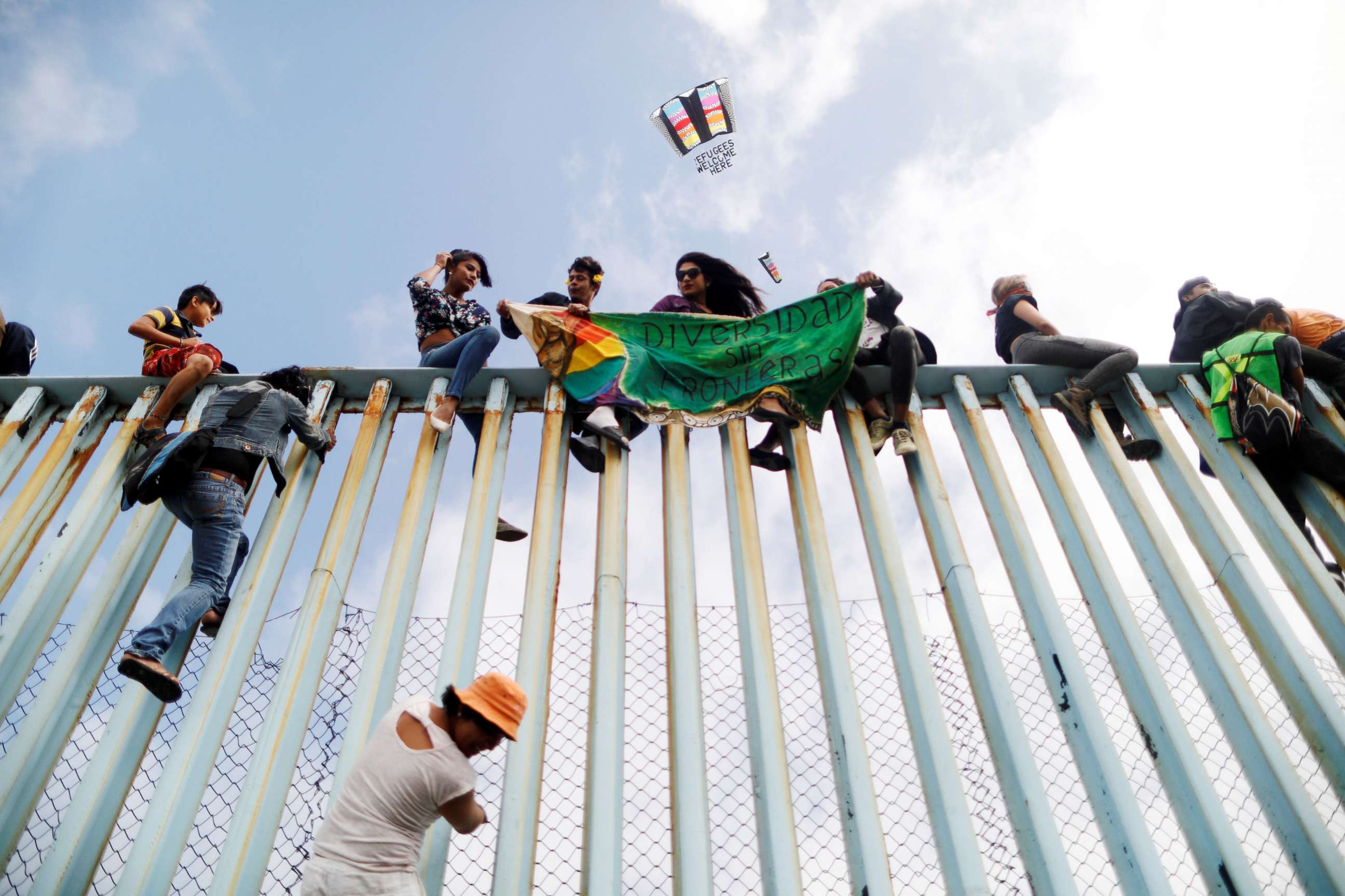 PHOTO: Members of a caravan of migrants from Central America sit on the border fence between Mexico and the U.S., as part of a demonstration prior to preparations for an asylum request in the U.S., in Tijuana, Mexico, April 29, 2018. 