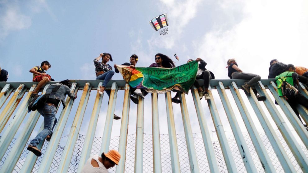 PHOTO: Members of a caravan of migrants from Central America sit on the border fence between Mexico and the U.S., as part of a demonstration prior to preparations for an asylum request in the U.S., in Tijuana, Mexico, April 29, 2018. 