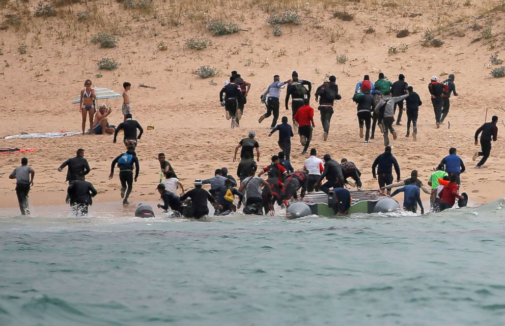 PHOTO: Moroccan migrants disembark from a dinghy at "Del Canuelo" beach after they crossed the Strait of Gibraltar from the coast of Morocco, in Tarifa, southern Spain, July 27, 2018.