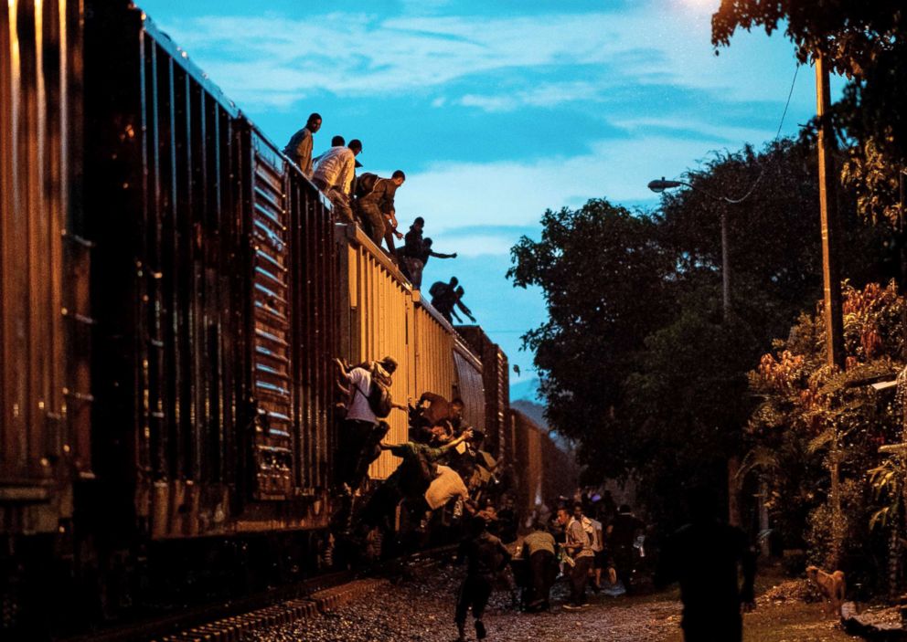 PHOTO: Undocumented migrants climb on a train known as "La Bestia" (The Beast), in Las Patronas town, Veracruz State, Mexico on Aug. 9, 2018 to travel through Mexico and reach the U.S.