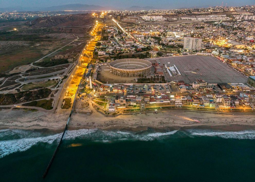 PHOTO: Aerial view of the U.S.(L) - Mexico (R) border fence extending into the Pacific ocean at Playas de Tijuana, Baja California state, Mexico, Aug. 10, 2018.