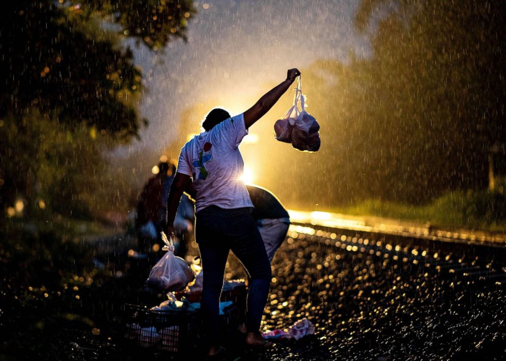 PHOTO: A volunteer of "Las Patronas" NGO, distributes bags of food among migrants, during their travel through Mexico to the U.S. on a train known as "La Bestia" (The Beast), in Las Patronas town, Veracruz state, Mexico, Aug. 9, 2018.