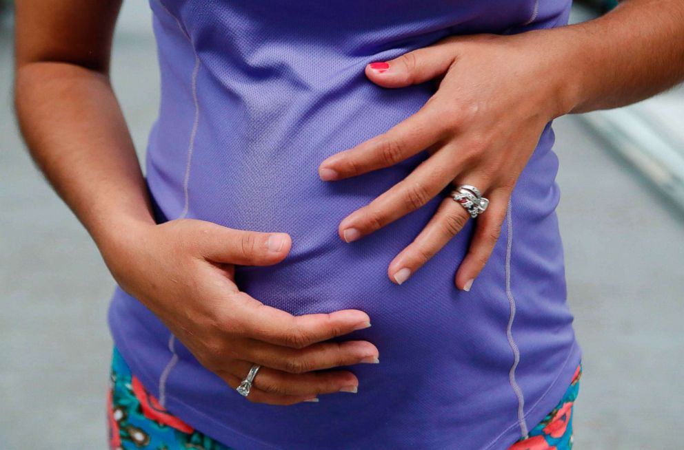 PHOTO: Honduran migrant Raquel Padilla, 27, shows her four-month pregnant belly at the "FM4 Paso Libre" shelter, an organization that offers housing, food, and legal advisoring to migrants during their stay in Guadalajara, Mexico, Aug. 10, 2018.