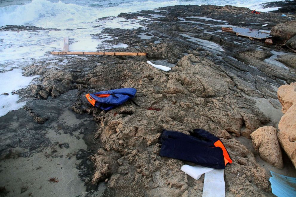 PHOTO: Life jackets are seen on the beach as Libyan Red Crescent team members recover bodies of migrants who drowned at sea off the coast Libya, June 19, 2018.