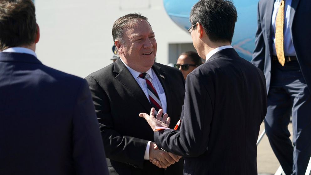 PHOTO: U.S. Secretary of State Mike Pompeo, center, is welcomed by officials upon his arrival at Haneda Airport in Tokyo Saturday, Oct. 6, 2018.