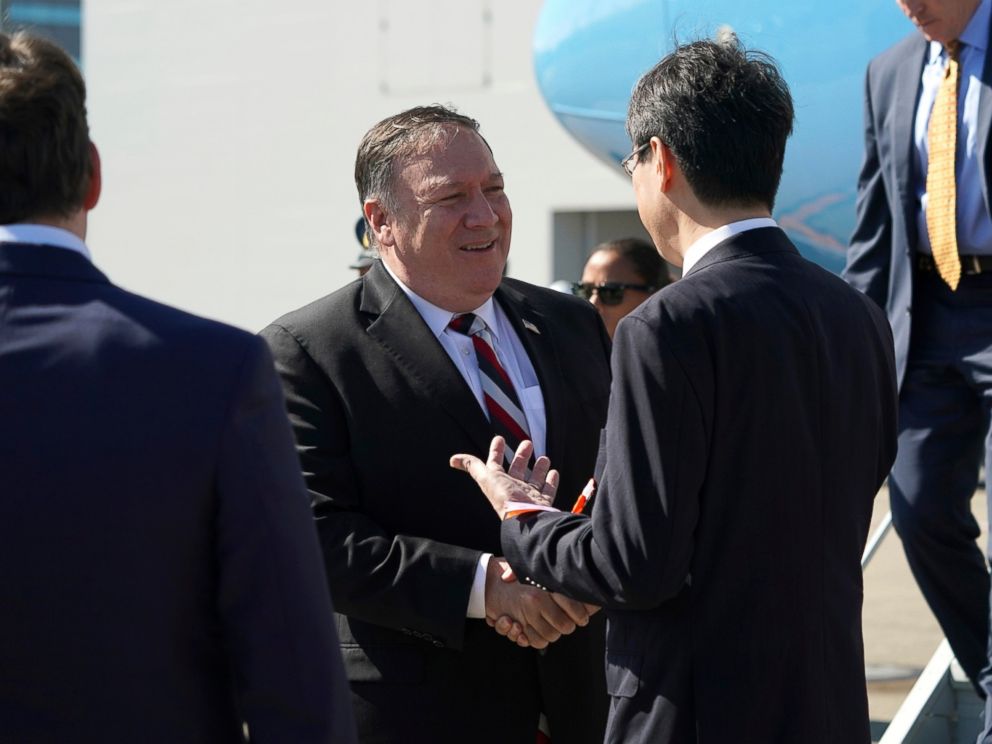 PHOTO: US Secretary of State Mike Pompeo, in the center, is greeted by authorities as he arrives at Tokyo's Haneda Airport on Saturday, October 6, 2018.