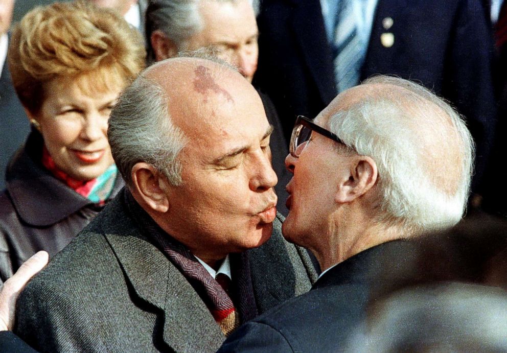 PHOTO: Soviet Leader Mikhail Gorbachev and his wife, Raisa, are welcomed by East German Leader Erich Honecker with a fraternal kiss in East Berlin, October 6, 1989.