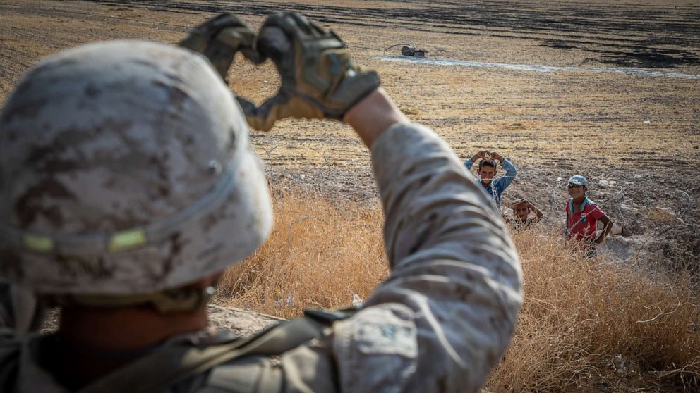 PHOTO: A U.S. Marine with 2nd Battalion, 7th Marine Regiment, attached to Special Purpose Marine Air-Ground Task Force Crisis Response Central Command interacts with children in an undisclosed location in Syria, Oct. 31, 2019.