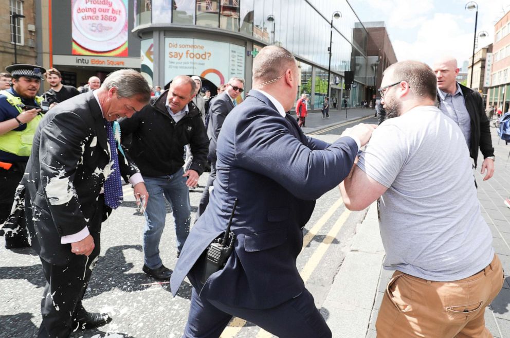 PHOTO: Brexit Party leader Nigel Farage gestures after being hit with a milkshake while arriving for a Brexit Party campaign event in Newcastle, Britain, May 20, 2019. 