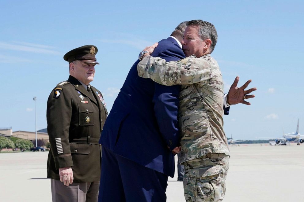 PHOTO: Secretary of Defense Lloyd Austin, center, greets Gen. Scott Miller, the former top U.S. commander in Afghanistan, as Joint Chiefs Chairman Gen. Mark Milley stands at left, upon Miller's return, July 14, 2021, at Andrews Air Force Base, Md.