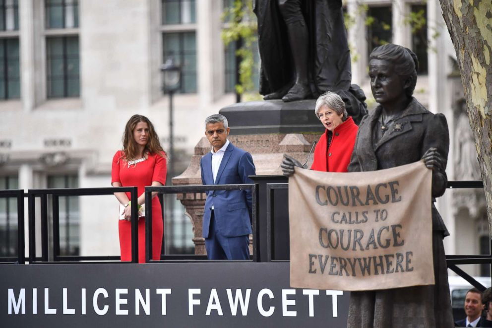 PHOTO: Prime Minister Theresa May speaks as British journalist Caroline Criado Perez (L) and London Mayor Sadiq Khan (C) listen during the unveiling of a statue of suffragist and women's rights campaigner Millicent Fawcett in London, April 24, 2018.