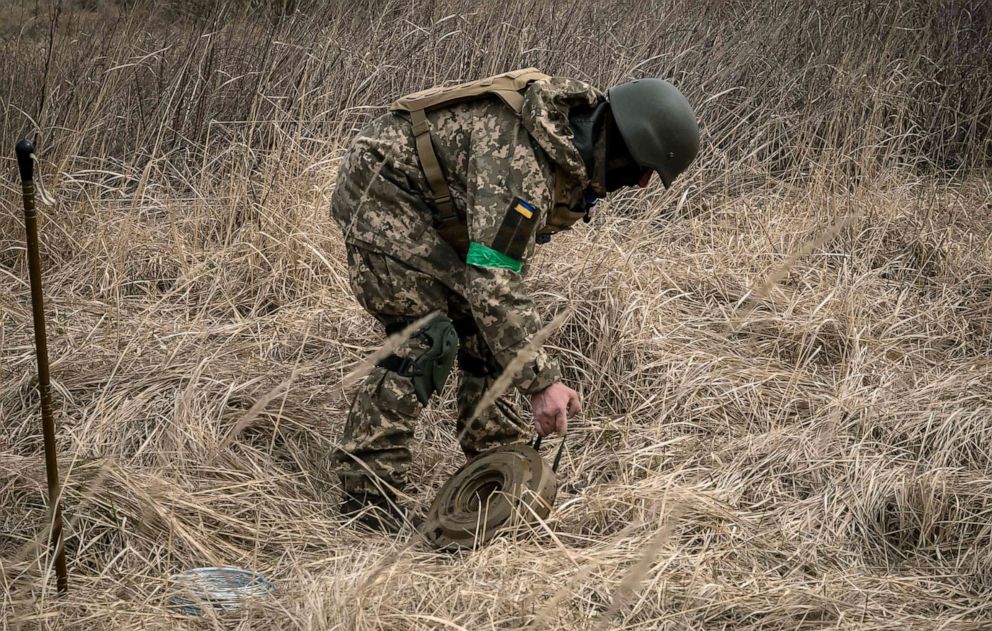 PHOTO: A member of a bomb disposal squad works in a mine field near Brovary, northeast of Kyiv, Ukraine, April 14, 2022.
