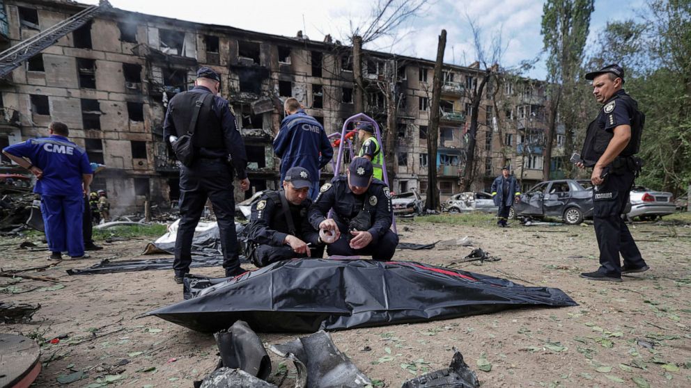 PHOTO: Police officers work next to the body of a person killed by a Russian missile strike, amid Russia's attack on Ukraine, in Kryvyi Rih, Dnipropetrovsk region, Ukraine June 13, 2023.