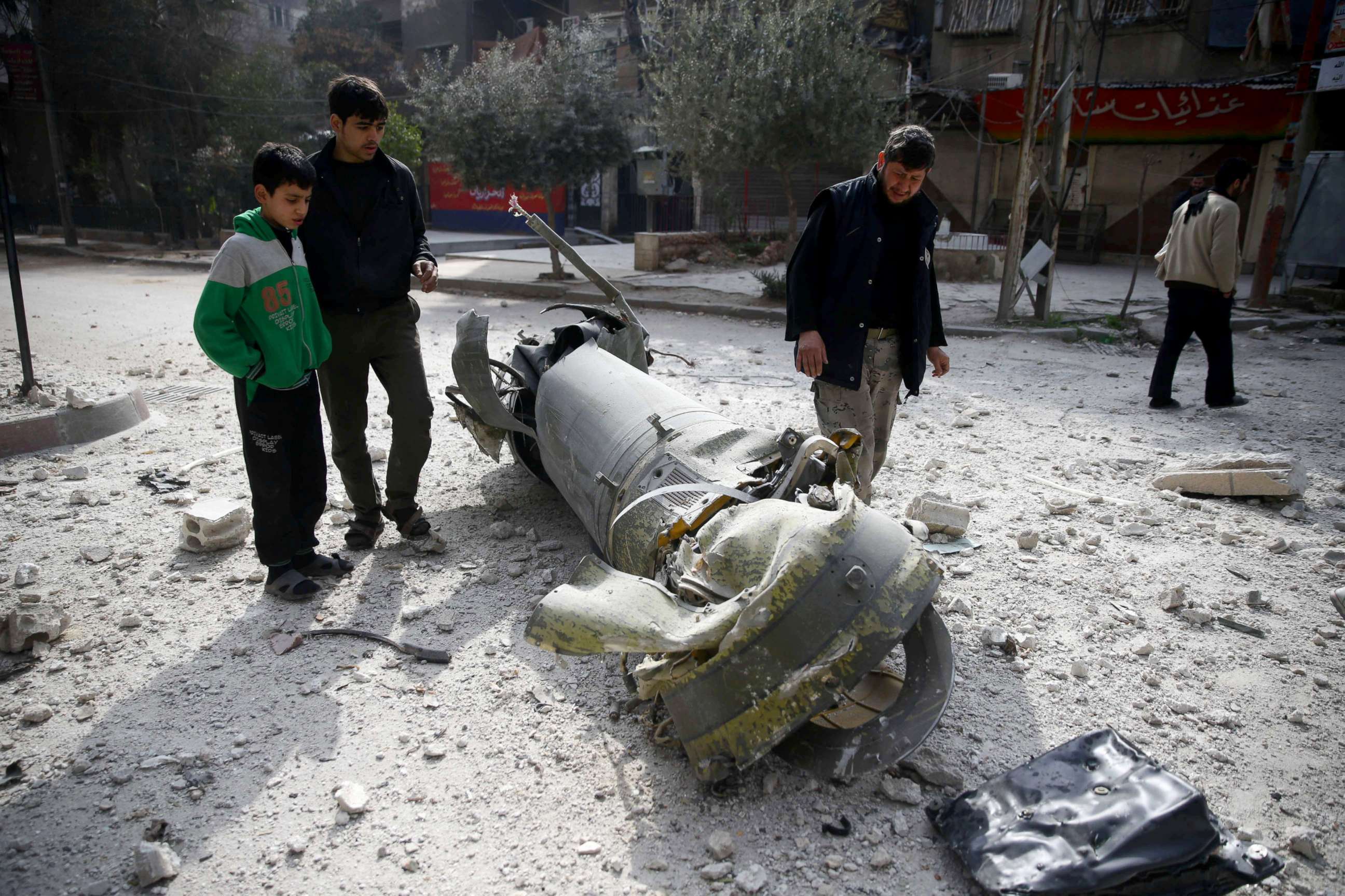 PHOTO: People inspect missile remains in the besieged town of Douma, in eastern Ghouta, Syria, Feb. 23, 2018.