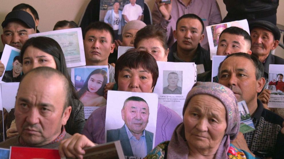 PHOTO: People living in Kazakhstan in 2019, hold up photos of missing relatives that disappeared in China.