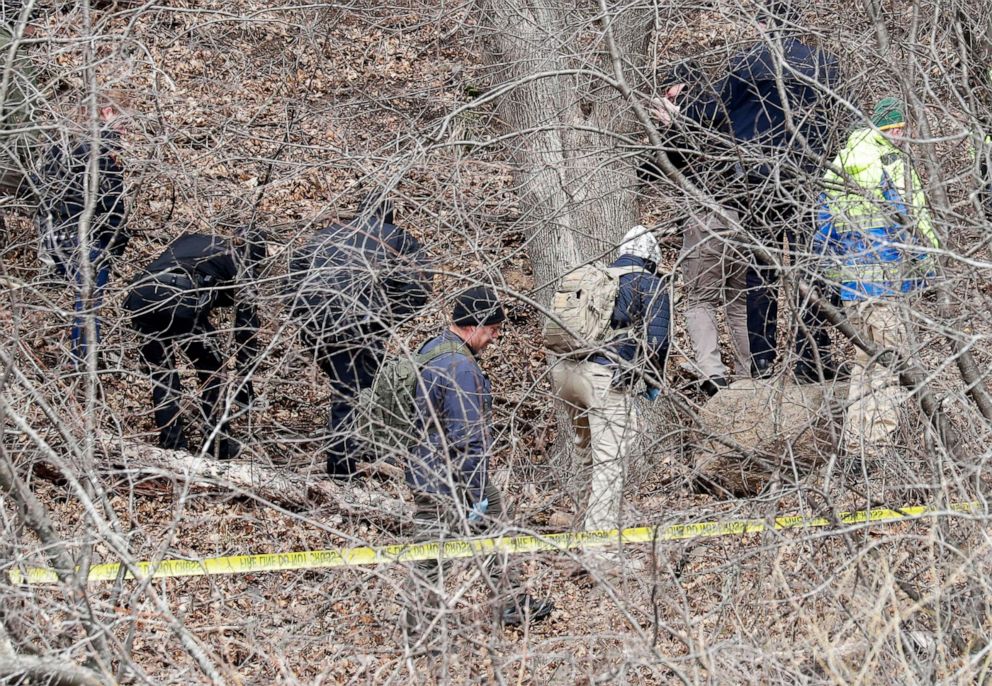 PHOTO: Officials search a wooded area next to the Jacob Leinenkugel Brewing Company during an investigation of the homicide of Iliana "Lily" Peters, in Chippewa Falls, Wis., April 26, 2022.