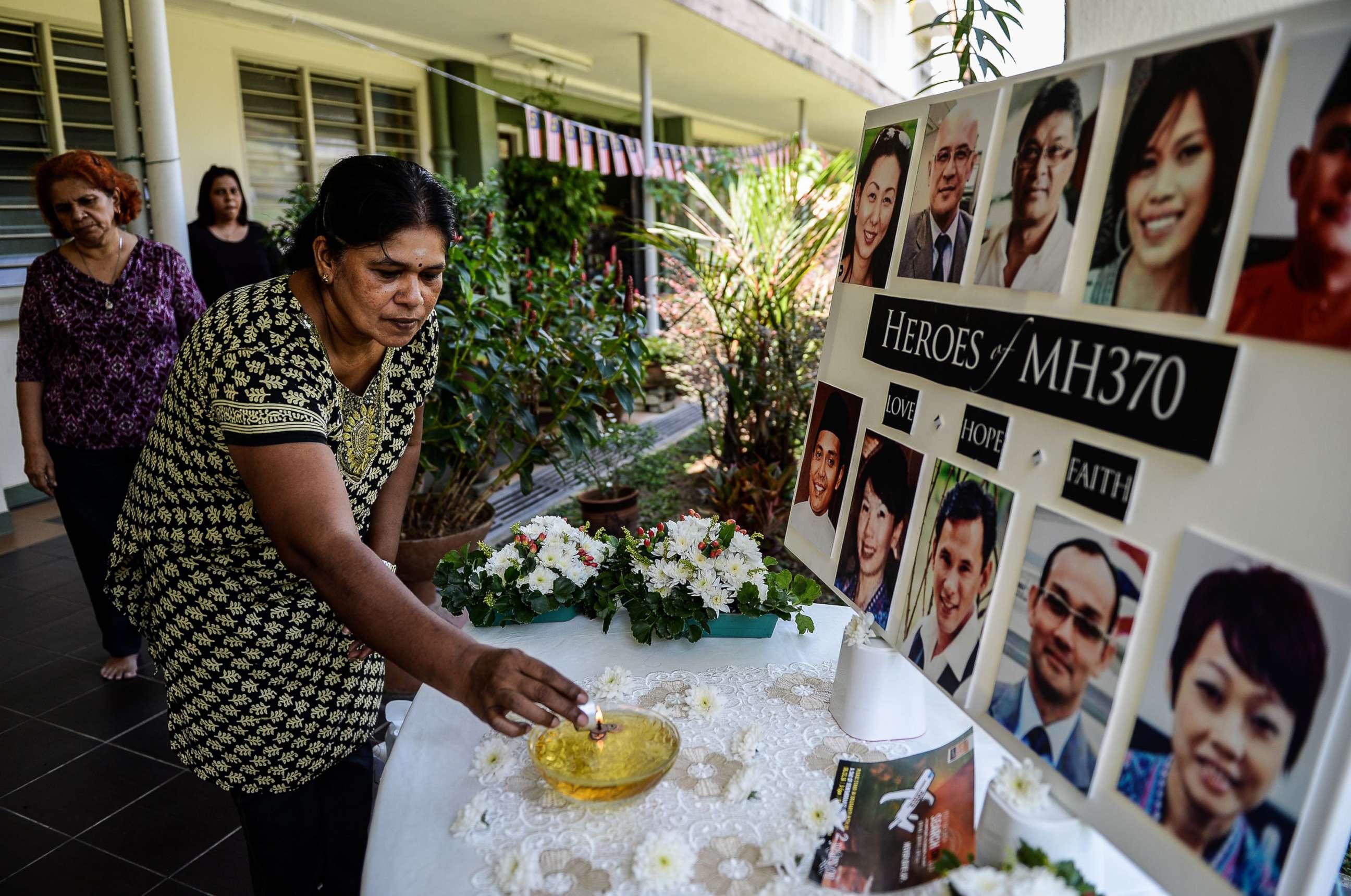 PHOTO: A school teacher lights a candle as she prays for passengers of missing Malaysia Airlines flight MH370 in Petaling Jaya on March 8, 2016.