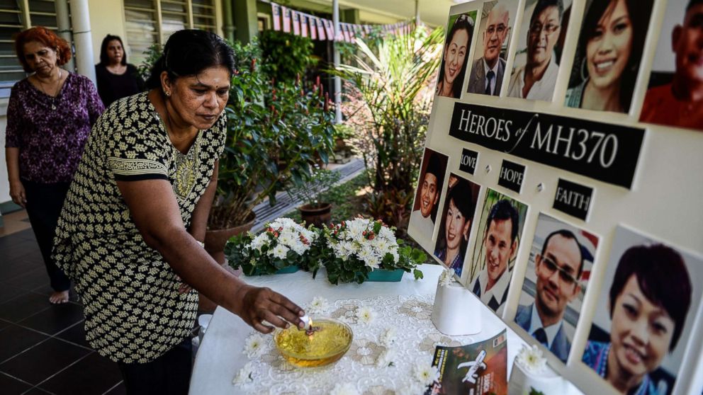 A school teacher lights a candle as she prays for passengers of missing Malaysia Airlines flight MH370 in Petaling Jaya on March 8, 2016. Malaysia and Australia said they remained "hopeful" of solving the mystery of flight MH370 as the second anniversary of the plane's disappearance arrived on March 8 with no end in sight for devastated families.