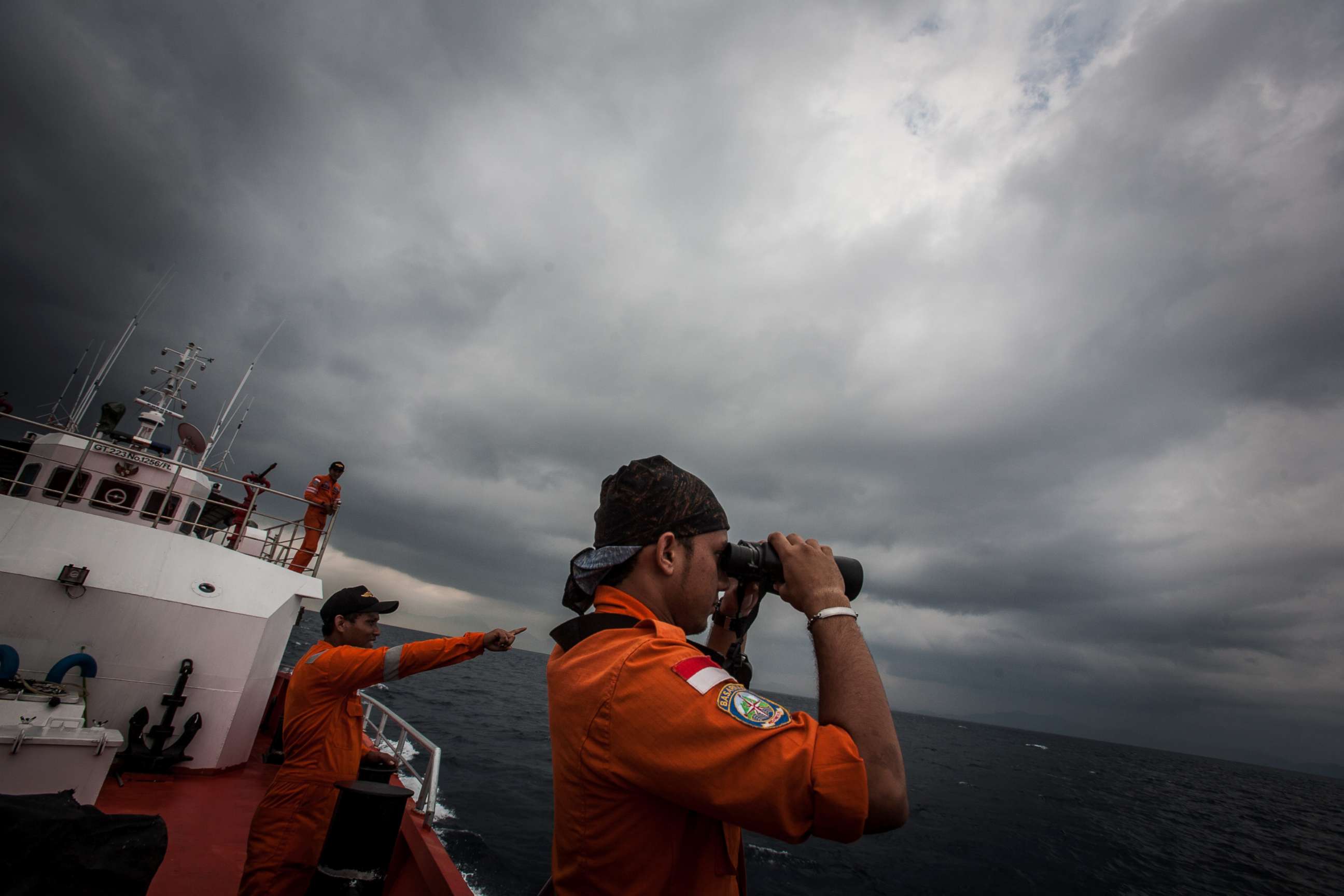 PHOTO: Indonesian national search and rescue agency personel watch over high seas during a search operation for missing Malaysia Airlines flight MH370 in the Andaman Sea on March 15, 2014.