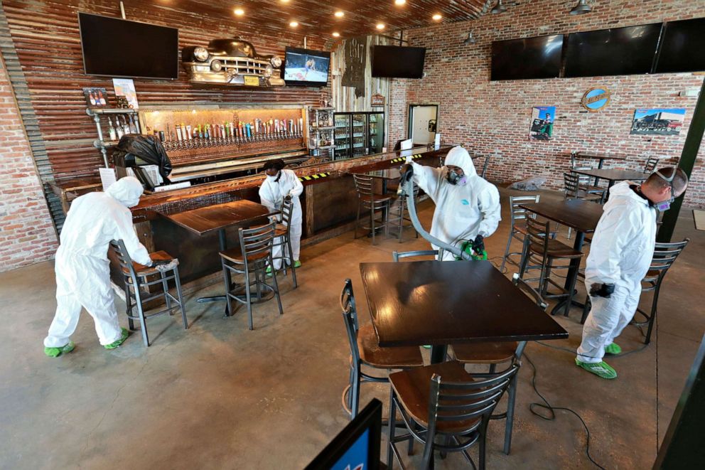 PHOTO: Workers from Servpro disinfect Mugshots restaurant in Tupelo, Miss., July 17, 2020, as the restaurant is preparing to open for business.