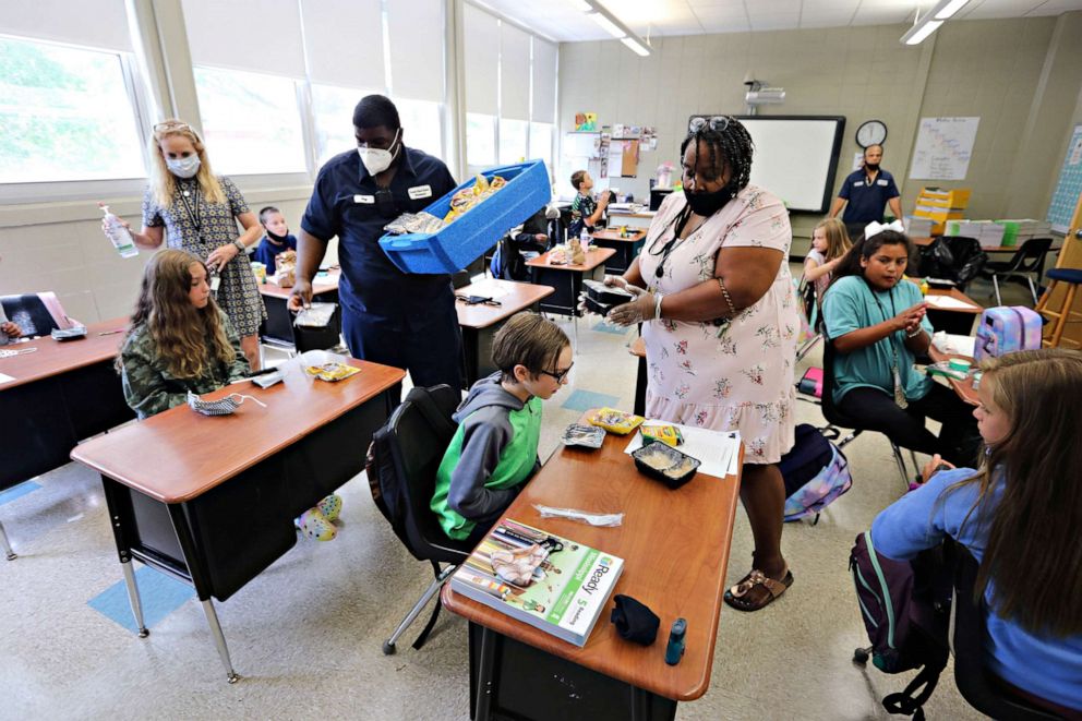 PHOTO: Ray Williams and Stephanie Patterson pass out lunches from the cafeteria to the children in their classrooms in Corinth, Miss.,July 27, 2020, 