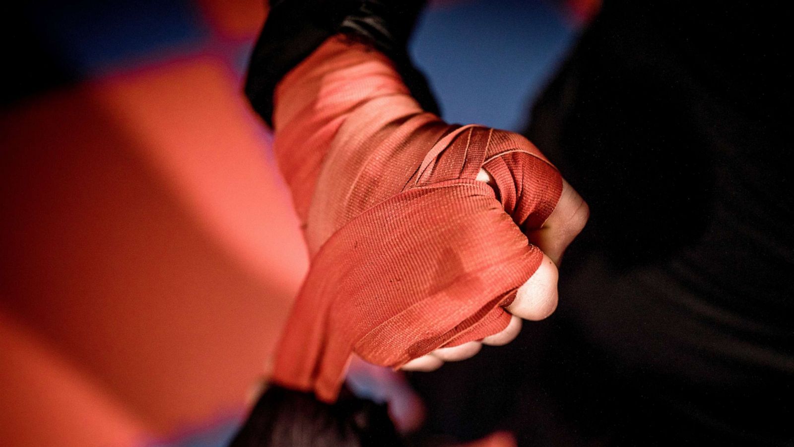 Female MMA fighter performs painful choke hold, Stock image