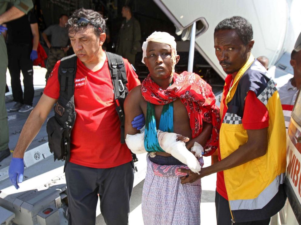 PHOTO: Turkish and Somali paramedics help a wounded man to a Turkish military plane transporting the injured to Turkey at the Mogadishu airport, Oct. 16, 2017, after a truck bomb explosion in the Somali capital. The attack left more than 200 people dead.