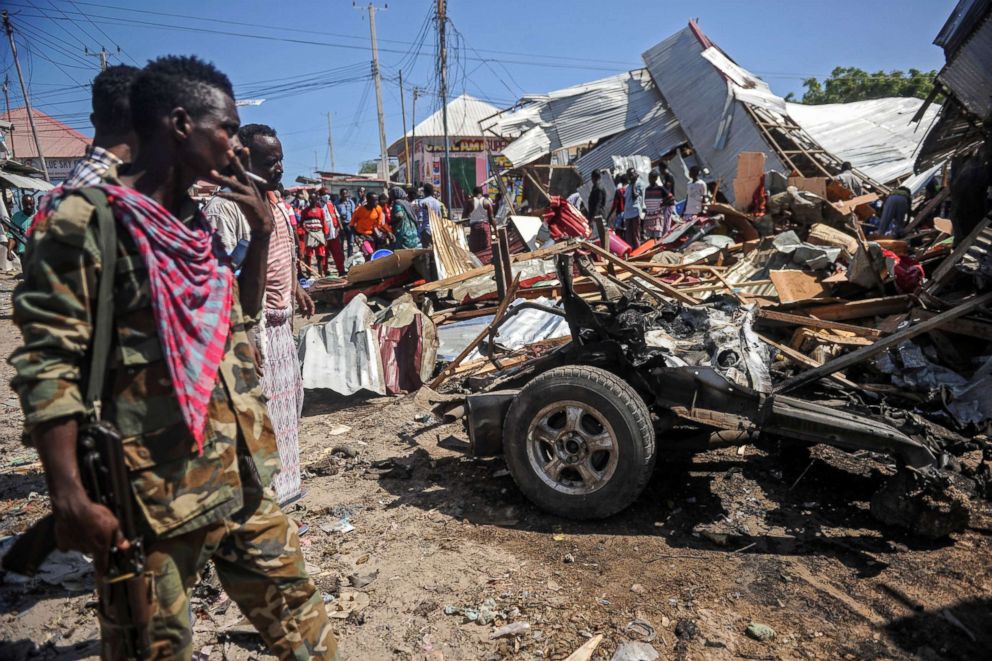 PHOTO: People gather by the site of a blast after a car bomb detonated at a busy market in the capital Mogadishu, Somalia, Nov. 26, 2018.