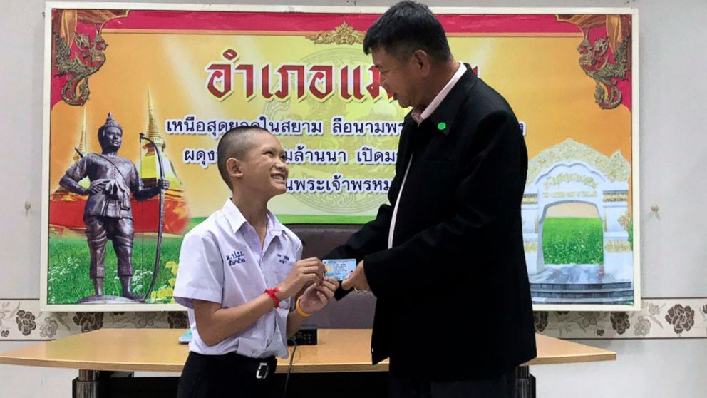 PHOTO: Mongkol Boonpiam, left, receives an identity card denoting Thai citizenship from Somsak Kunkam, Sheriff of Mae Sai during a ceremony in Chiang Rai province, Thailand, Aug. 8, 2018.