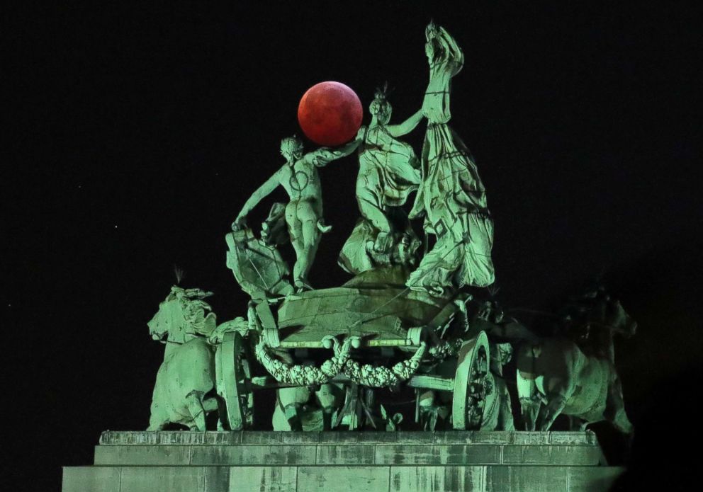 PHOTO: The moon is seen beside a quadriga on the top of the Cinquantenaire arch during a total lunar eclipse, known as the "Super Blood Wolf Moon", in Brussels, Jan. 21, 2019.
