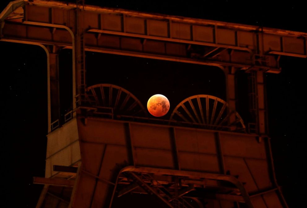PHOTO: A view of the blood moon next to the mine winding tower of Ewald colliery during the first total lunar eclipse of the year in Herten, Germany, Jan. 21, 2019.