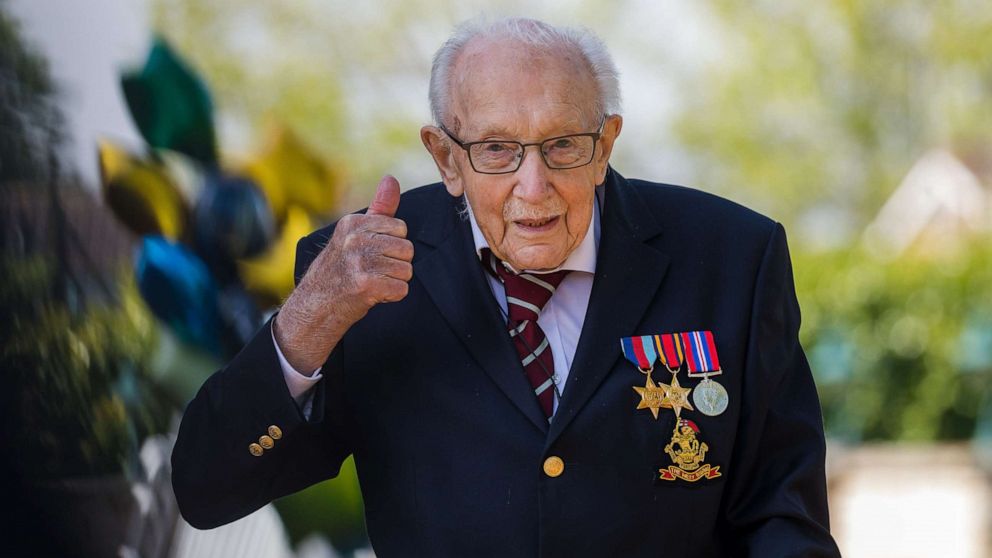 PHOTO: British veteran Captain Tom Moore reacts after completing the 100th length of his back garden in Marston Moretaine, Bedfordshire, Britain, April 16, 2020. 