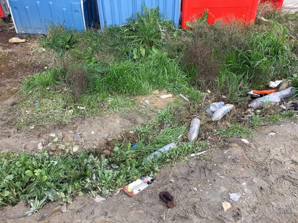  Plastic bottles and human faeces are scattered around the Moria refugee camp on the Greek island of Lesbos.