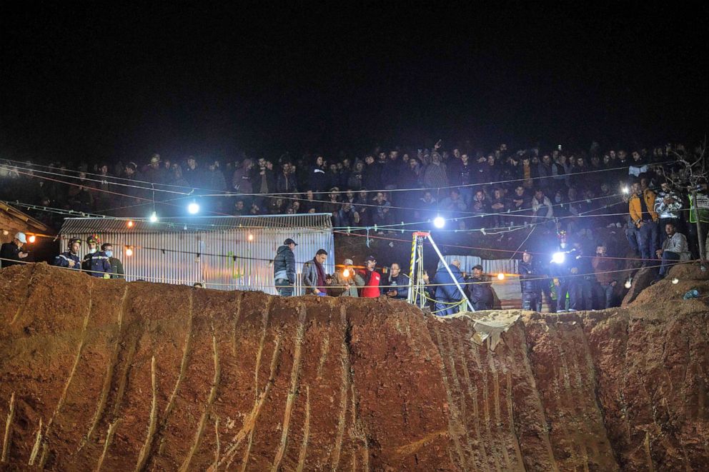 PHOTO: Bystanders watch as rescuers search for a five-year-old boy trapped in a deep well near Bab Berred in Morocco's rural northern province of Chefchaouen on Feb. 3, 2022. 