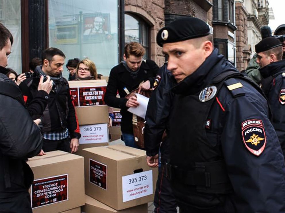 PHOTO: Russian policemen surround Russian gay-rights activists standing next to boxes allegedly containing signed petitions calling for a probe into a reported crackdown on Chechnyas LGBT community, during a rally in central Moscow on May 11, 2017.