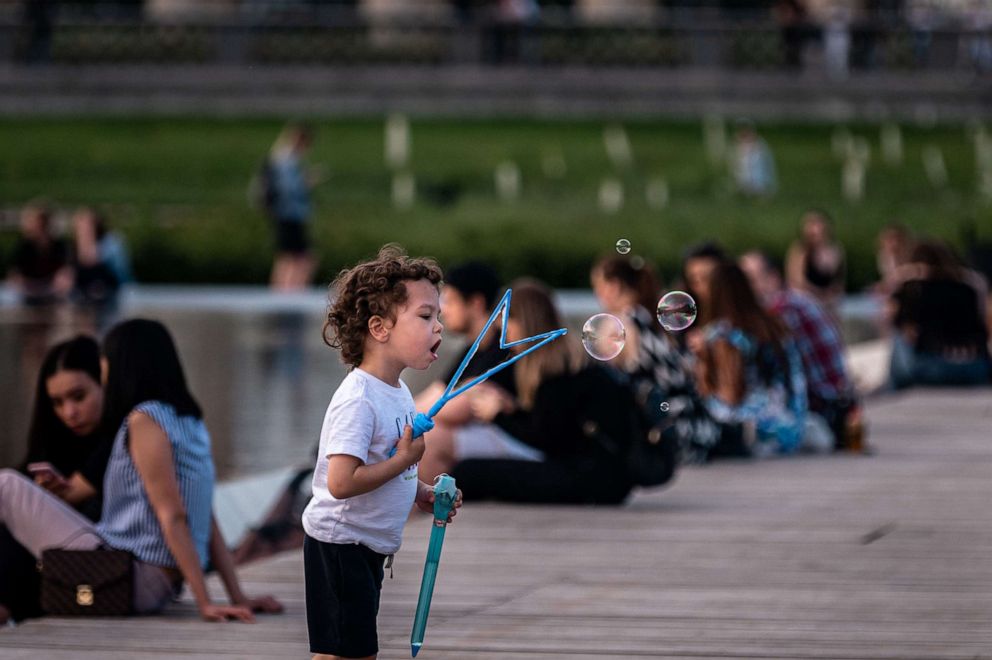 PHOTO: A boy makes soap bubbles at Gorki park in Moscow on June 9, 2020, on the first day after Moscow lifted a range of anti-coronavirus measures including a strict lockdown set up to curb the spread of the COVID-19 caused by the novel coronavirus.