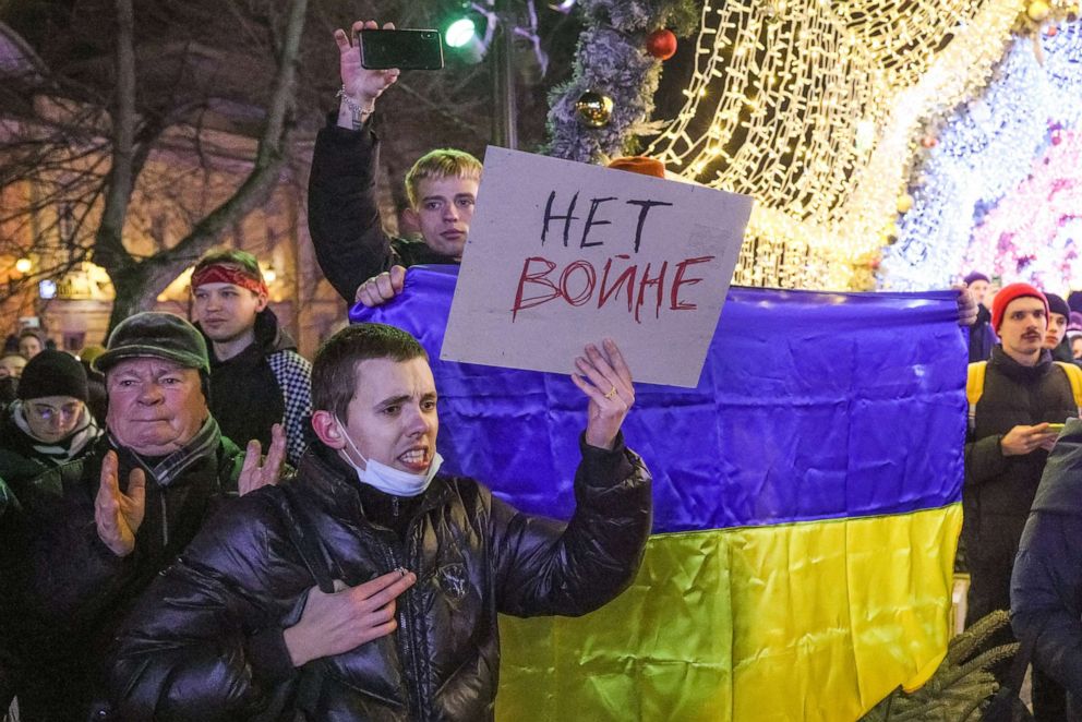 PHOTO: Demonstrators with a Ukrainian national flag and a sign with a message reading "No To War" are seen during an unsanctioned anti-war protest in Pushkin Square in central Moscow, Feb. 24 2022.
