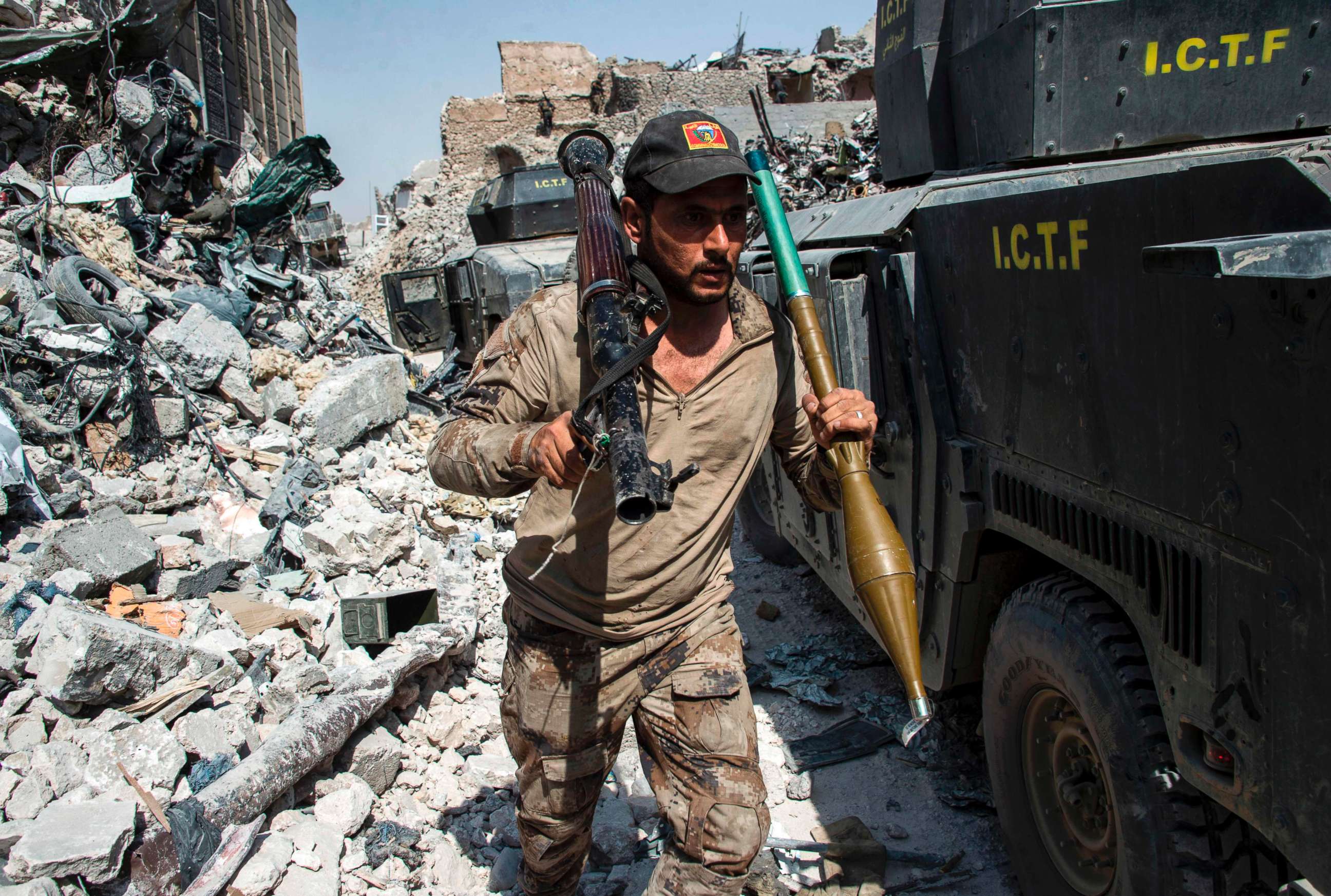 PHOTO: A member of the Iraqi forces walks through the rubble past humvees as he carries a rocket-propelled grenade and launcher in the Old City of Mosul, July 10, 2017.