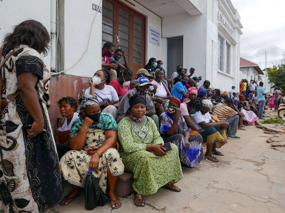 PHOTO: People await the arrival of more ships from Palma district with people fleeing attacks by rebel groups, in Pemba, Mozambique, March 29, 2021.