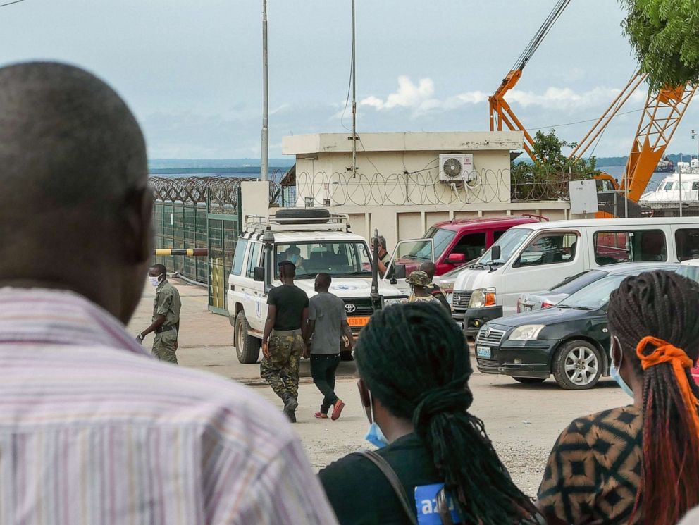 PHOTO: People await the arrival of more ships from Palma district with people fleeing attacks by rebel groups, in Pemba, Mozambique, March 29 2021.