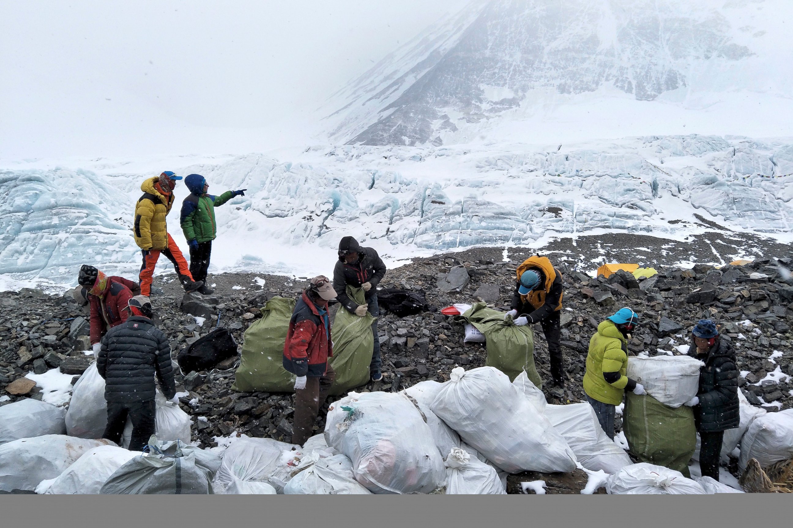 PHOTO: In this May 8, 2017, file photo released by Xinhua News Agency, people collect garbage at the north slope of the Mount Everest in southwest China's Tibet Autonomous Region.