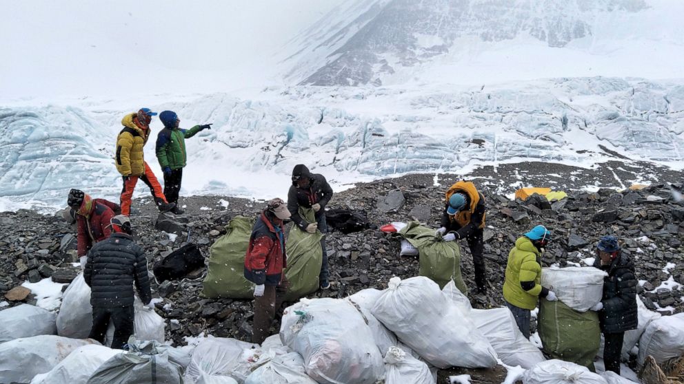 PHOTO: In this May 8, 2017, file photo released by Xinhua News Agency, people collect garbage at the north slope of the Mount Everest in southwest China's Tibet Autonomous Region.
