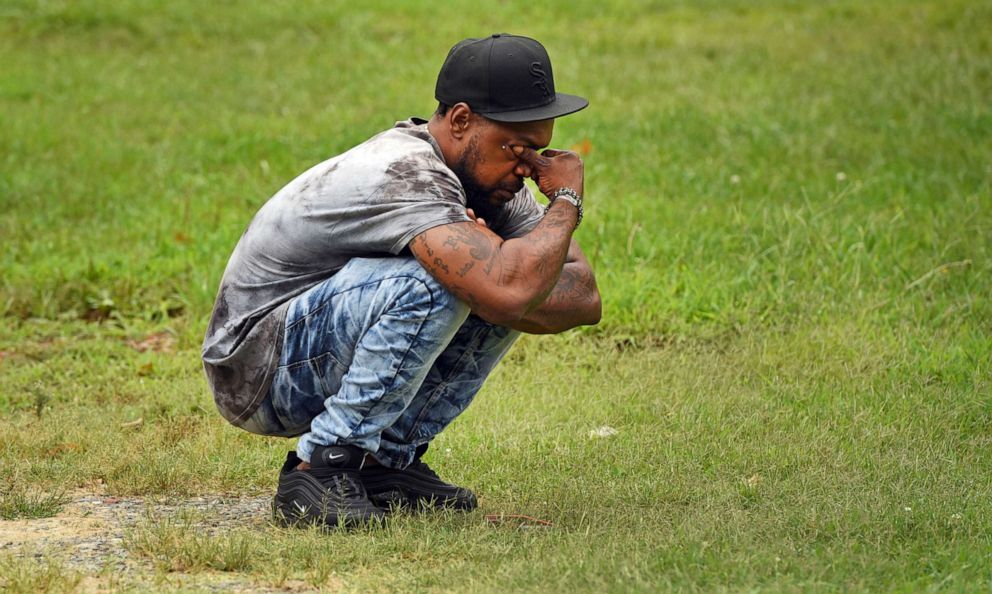 PHOTO: Kiwannie James Sr. wipes his eyes as he waits to get word about his son after a shooting that left one student dead at Mount Tabor High School in Winston-Salem, N.C., Sept. 1, 2021. James got word that his son was safe about 10 minutes later. 