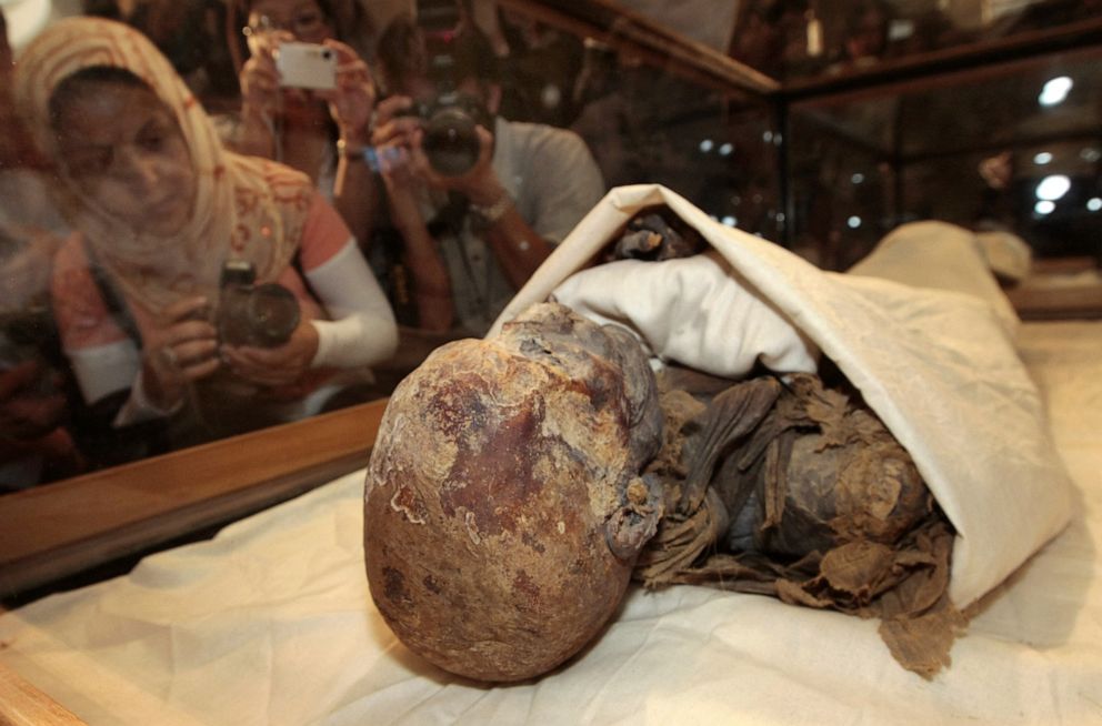 PHOTO: People take photos of the mummified remains of Queen Hatshepsut, ancient Egypt's most famous female pharaoh, after being unveiled at the Cairo Museum in Egypt on June 27, 2007.