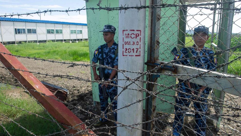 Armed Myanmar border guard police are posted at the gate of Nga Khu Ya camp in Maungdaw, Rakhine state, a facility to process Rohingya refugees returning under repatriation program with Bangladesh, June 28, 2018.