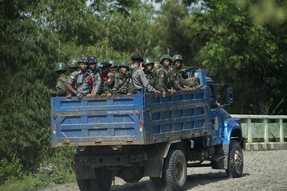 PHOTO: Armed military troops and police officers travel in trucks through Maungdaw, Myanmar,  Oct. 14, 2016.