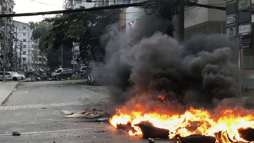 PHOTO: Black smoke rises from tires on a road in Yangon, Myanmar, on March 27, 2021.