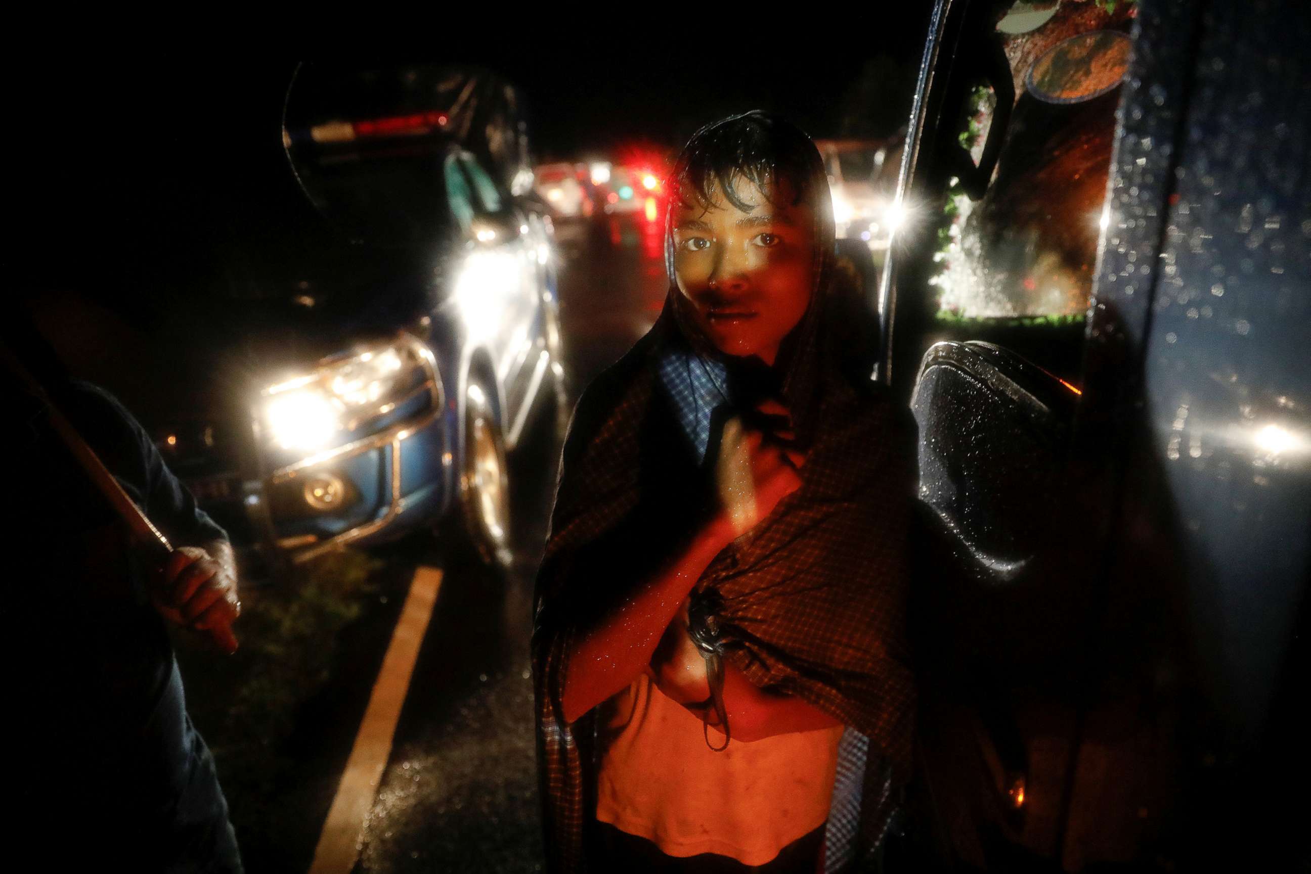 PHOTO: A man watches as bodies of Rohingya refugees are transported after their boat with passengers fleeing from Myanmar capsized off the Inani beach near Cox's Bazar, Bangladesh, Sept. 28, 2017.   