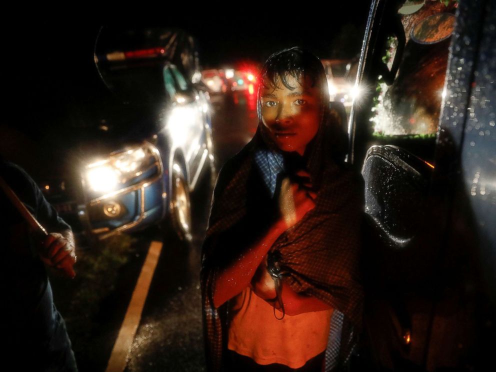 PHOTO: A man watches as bodies of Rohingya refugees are transported after their boat with passengers fleeing from Myanmar capsized off the Inani beach near Coxs Bazar, Bangladesh, Sept. 28, 2017.